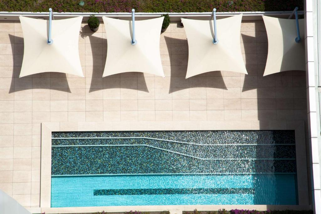 a swimming pool with towels hanging on a clothes line at Grand Papua Hotel, a member of Radisson Individuals in Port Moresby