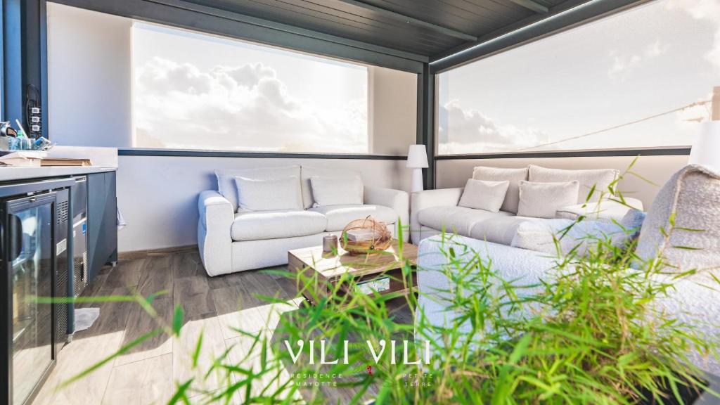 a living room with two couches and a table at Résidence Vili Vili in Dzaoudzi