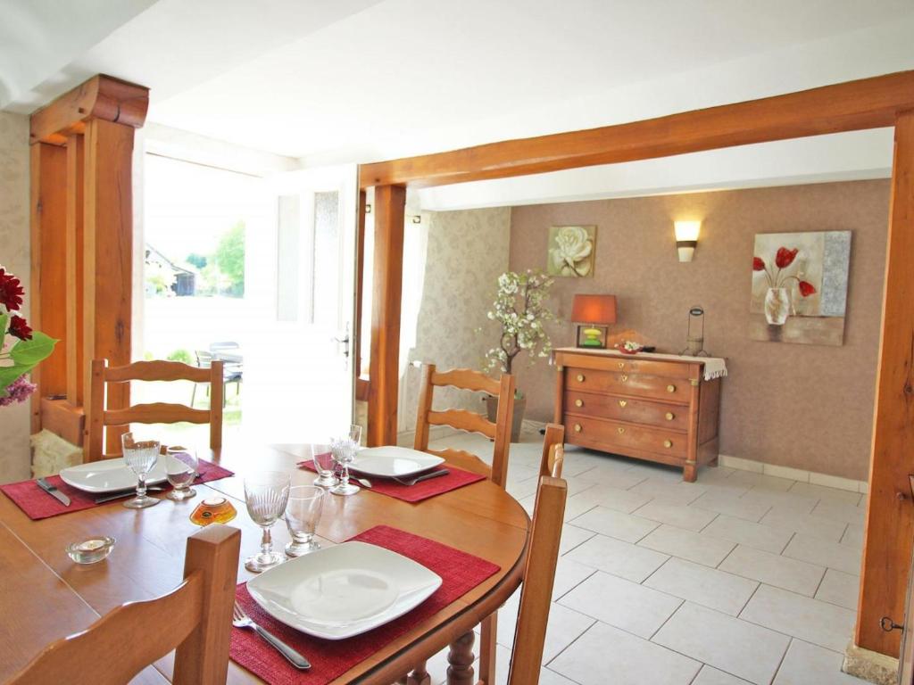 a dining room with a table and chairs and a kitchen at Gîte Champosoult, 5 pièces, 6 personnes - FR-1-497-27 in Champosoult