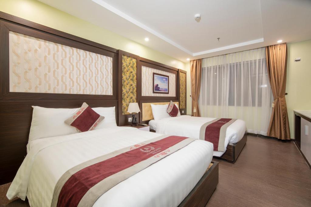 Postel nebo postele na pokoji v ubytování Le Indochina Hotel & Beach Da Nang City