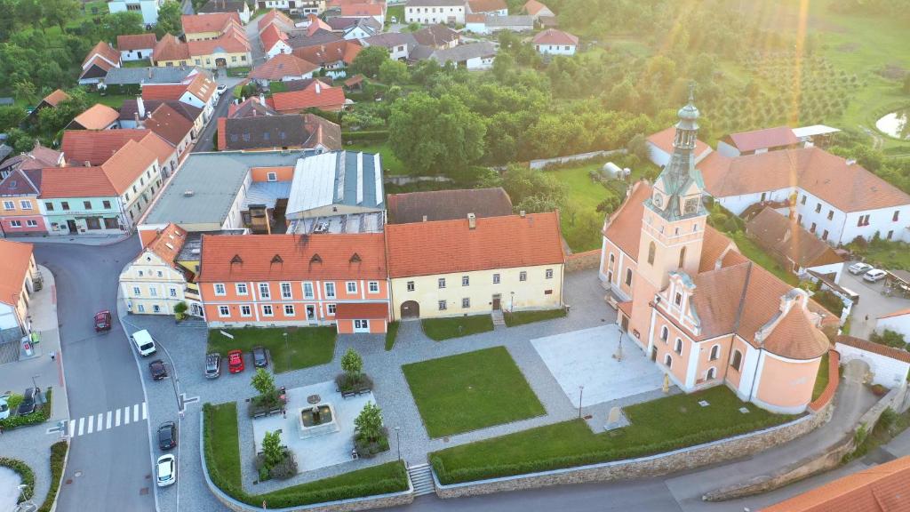 an aerial view of a town with a church at Hotel Pod Stráží in Lhenice