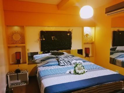 a bedroom with two stuffed animals sitting on a bed at Stylus Hotel in Iquitos