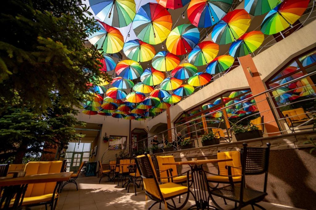 a restaurant with colorful umbrellas hanging from the ceiling at Complex Marinn Costinesti in Costinesti