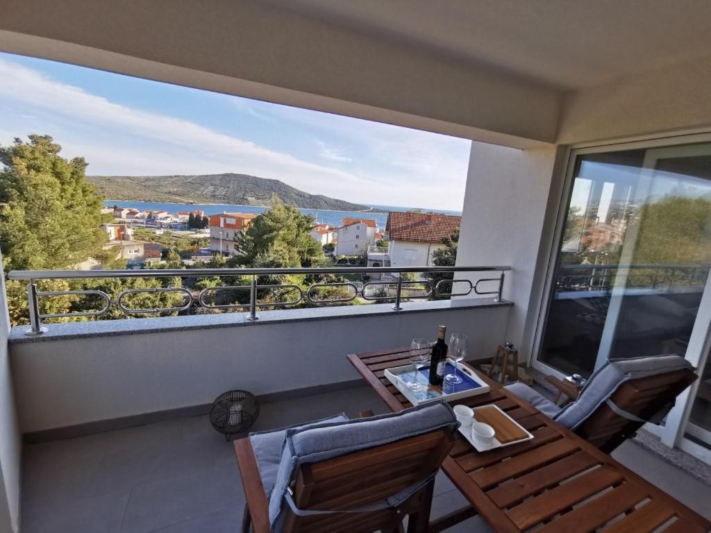 a balcony with a table and chairs and a view at Apartment Pinia in Primošten