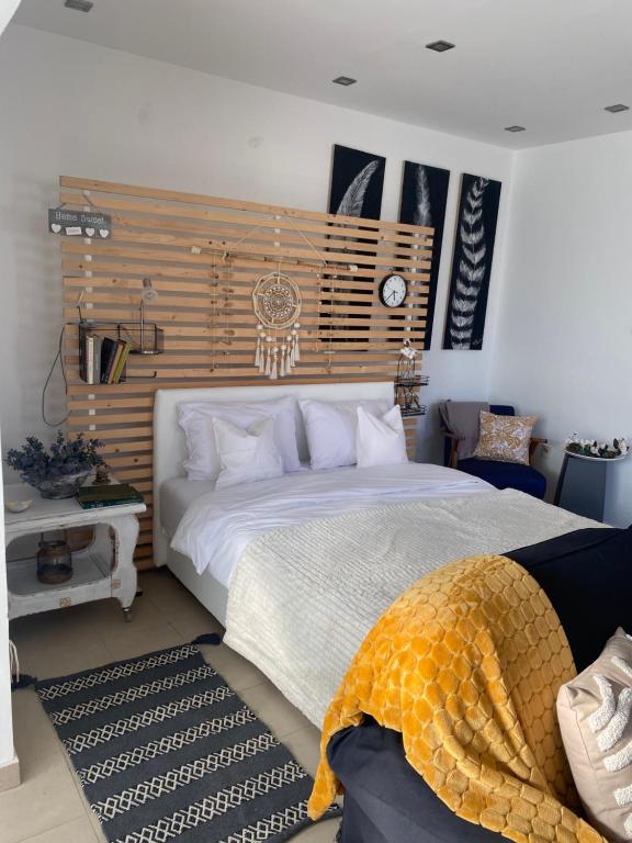 a bedroom with a large bed with a wooden headboard at Green garden in Žarkovo