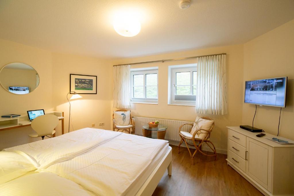ein Schlafzimmer mit einem Bett und einem TV. in der Unterkunft Haus Therese *FeWo 14* in Wittdün