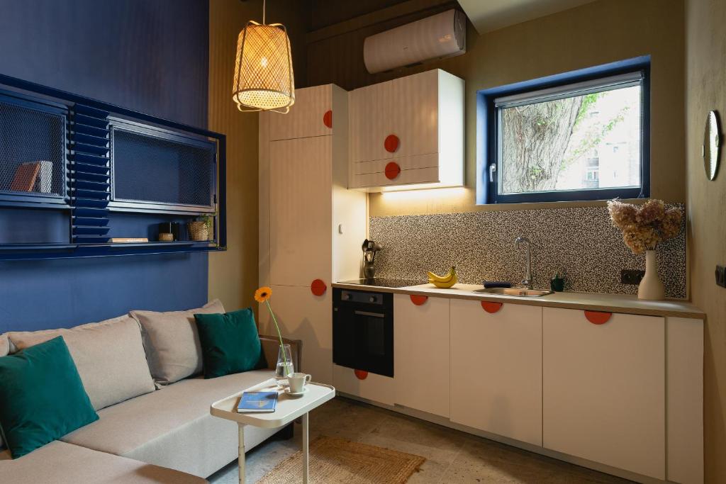 een woonkamer met een bank en een keuken bij City Garage Studio - Lwowska 9 in Warschau