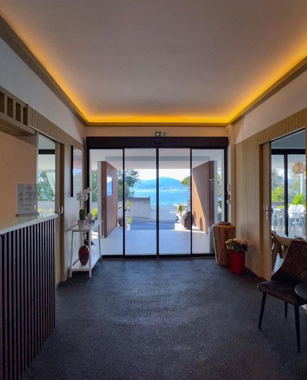 a lobby with a view of the ocean at Hotel l'Isolella in Porticcio