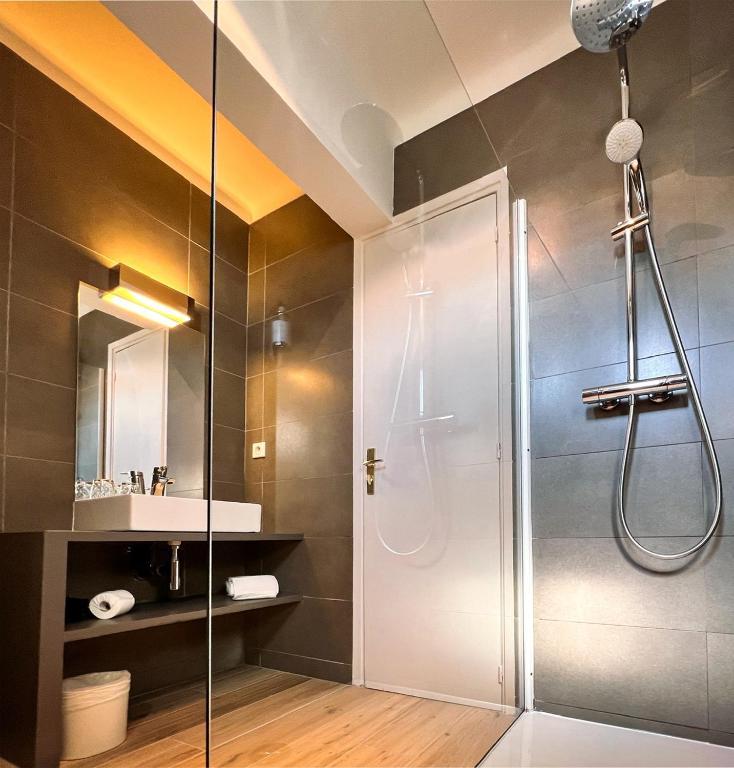 a bathroom with a shower and a sink at Hotel l'Isolella in Porticcio