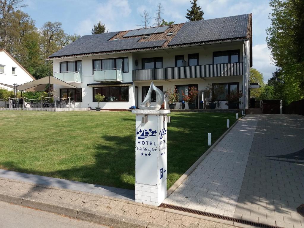 a house with a sign in front of it at Hotel Garni Waldsegler in Bad Sachsa