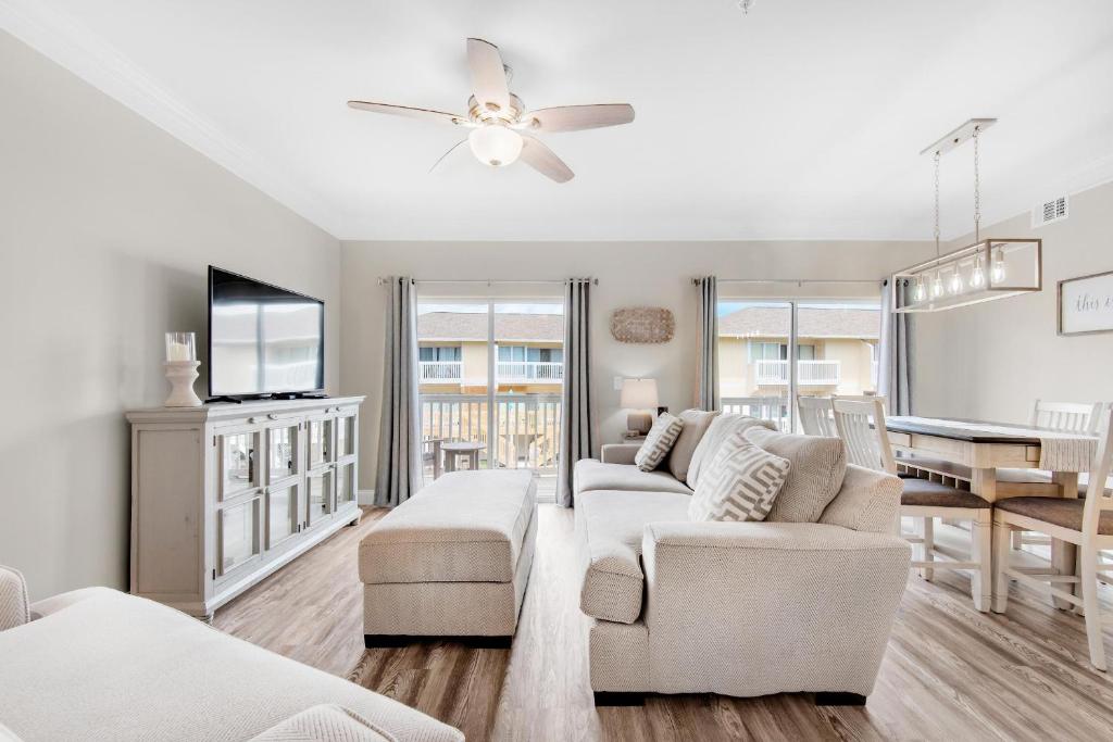 a living room with a couch and a tv at Sandpiper Cove 4114 in Destin