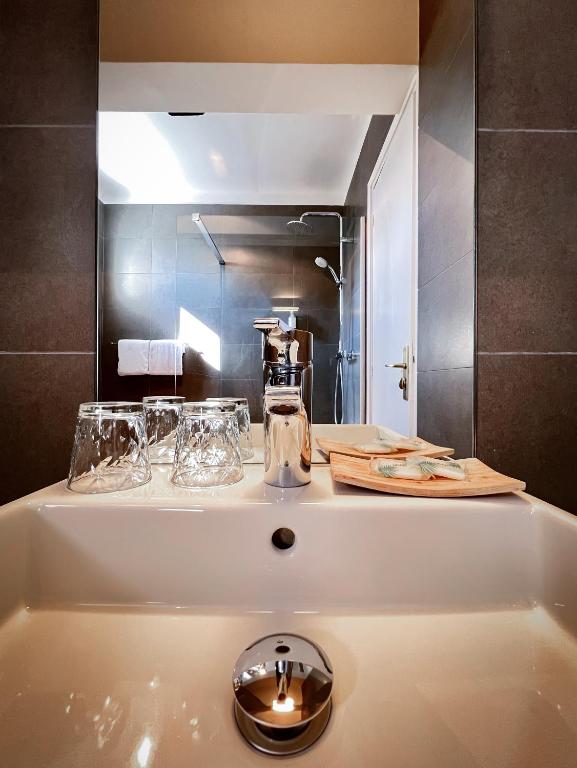 a bath tub with glasses on top of it at Hotel l'Isolella in Porticcio