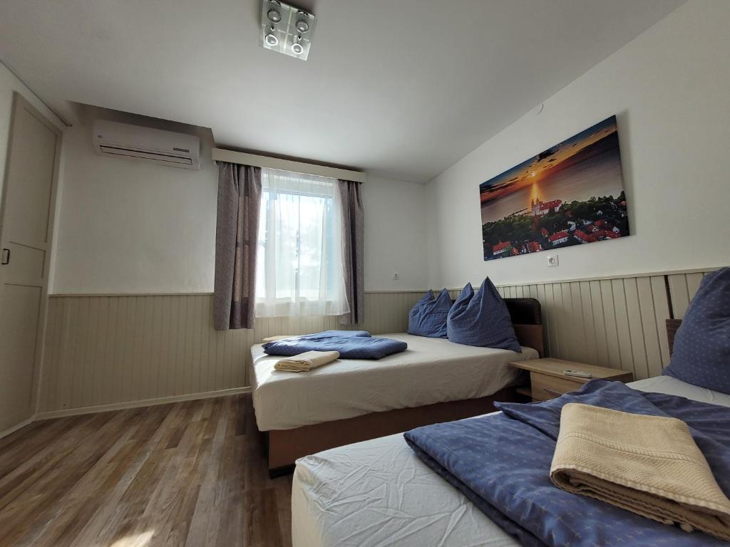 pokój hotelowy z dwoma łóżkami i oknem w obiekcie VilLa AdeLe w Siófoku