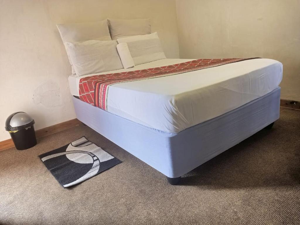 a bed in a room with a bedvisorvisor at Moonlight Guesthouse in Pretoria
