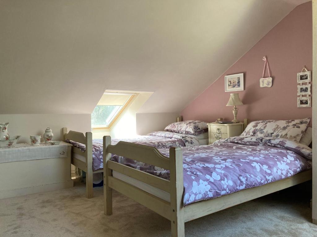 a bedroom with a bed and a window and a sink at Cosy twin room with private bathroom in Kent