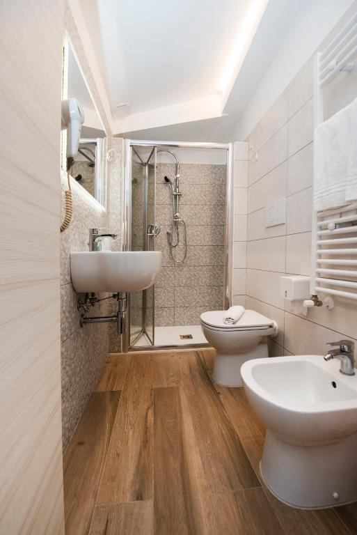 a bathroom with a sink and a toilet and a shower at Gu Hotel in Guidonia