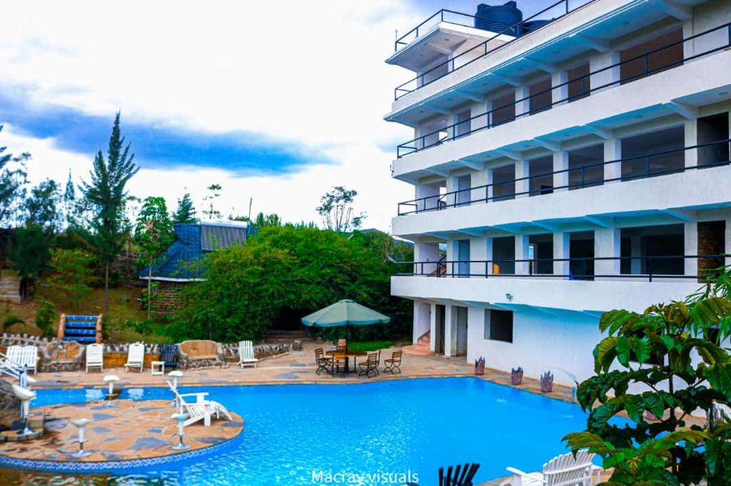 a large swimming pool in front of a hotel at Lake Elementaita Nature Pebbles & Spar in Gilgil