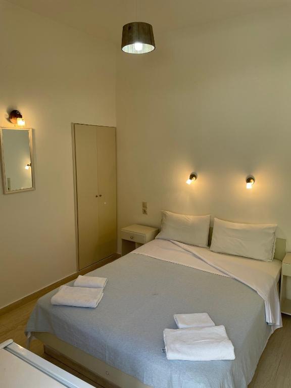 a bedroom with a large bed with towels on it at Villa Sylvia in Matala