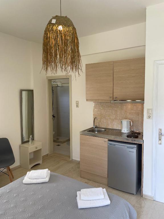 a kitchen with a bed and a sink and a table at Villa Sylvia in Matala