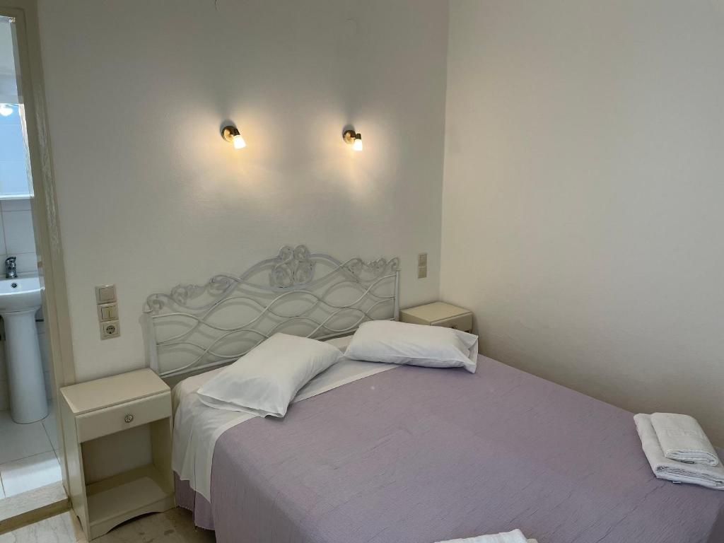a bedroom with a bed with two white pillows at Villa Sylvia in Matala