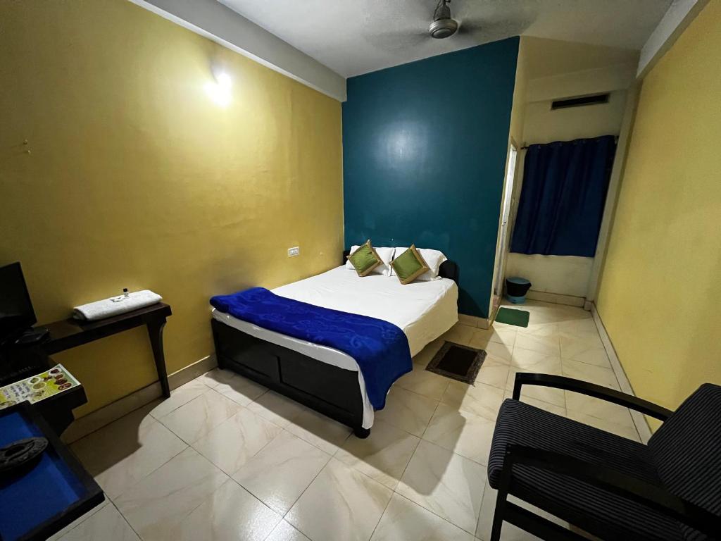 Postel nebo postele na pokoji v ubytování Hotel Shivanand