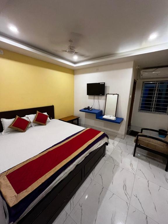 Postel nebo postele na pokoji v ubytování Hotel Shivanand