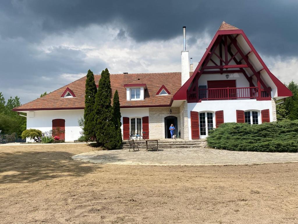 ein großes Haus mit einem roten und weißen Dach in der Unterkunft Le Montmieri in Dax