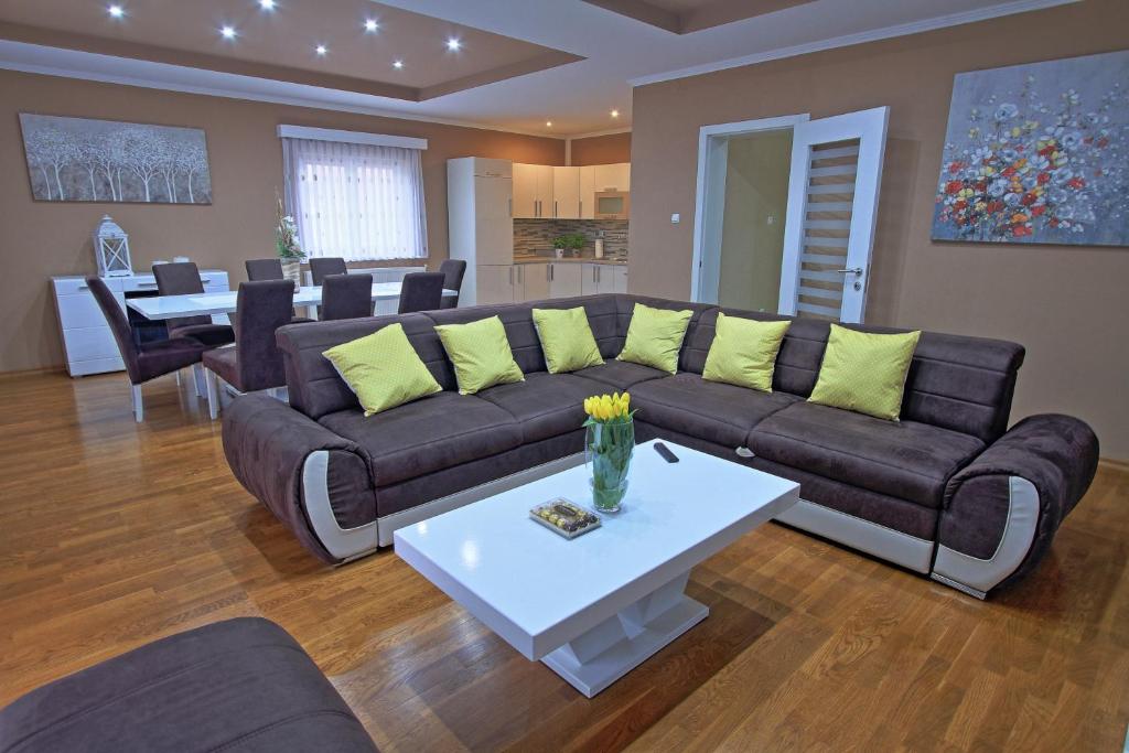 a living room with a couch and a table at Holiday House Lana in Otočac