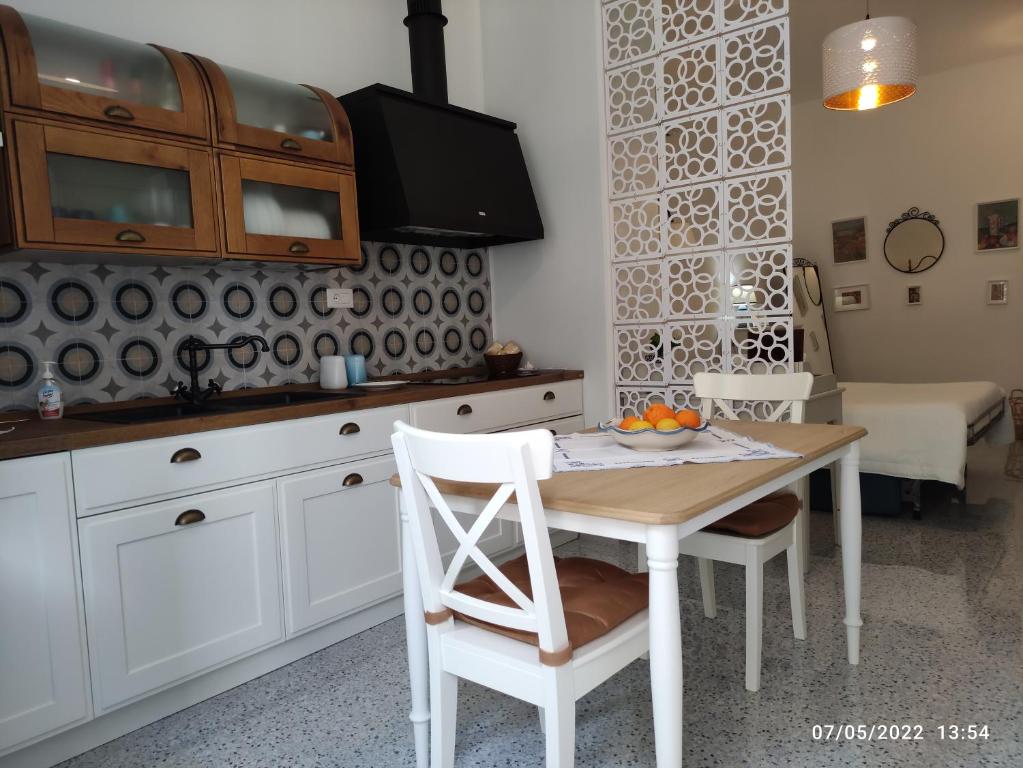 a kitchen with a table with a bowl of fruit on it at Casa del Mare Appartamento Bucceri Salvatore in Letojanni