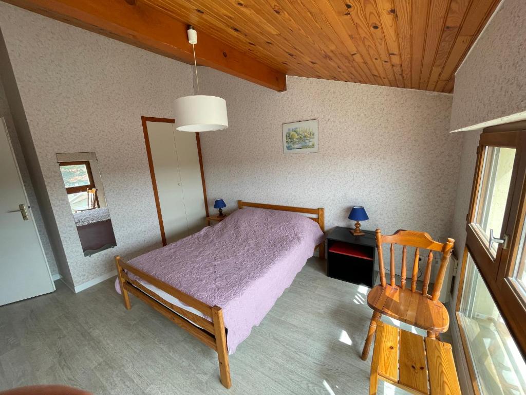 a bedroom with a bed and a wooden ceiling at L&#39;Abri Côtier in Mimizan