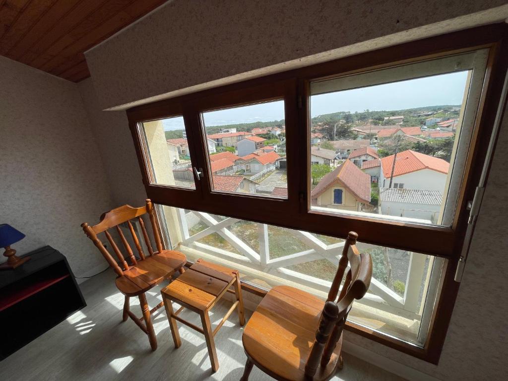 a room with two chairs and a large window at L&#39;Abri Côtier in Mimizan