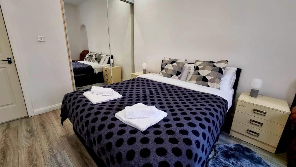 a bedroom with a black and white bed with mirrors at Entire, lovely apartment with a bath tub in Glasgow