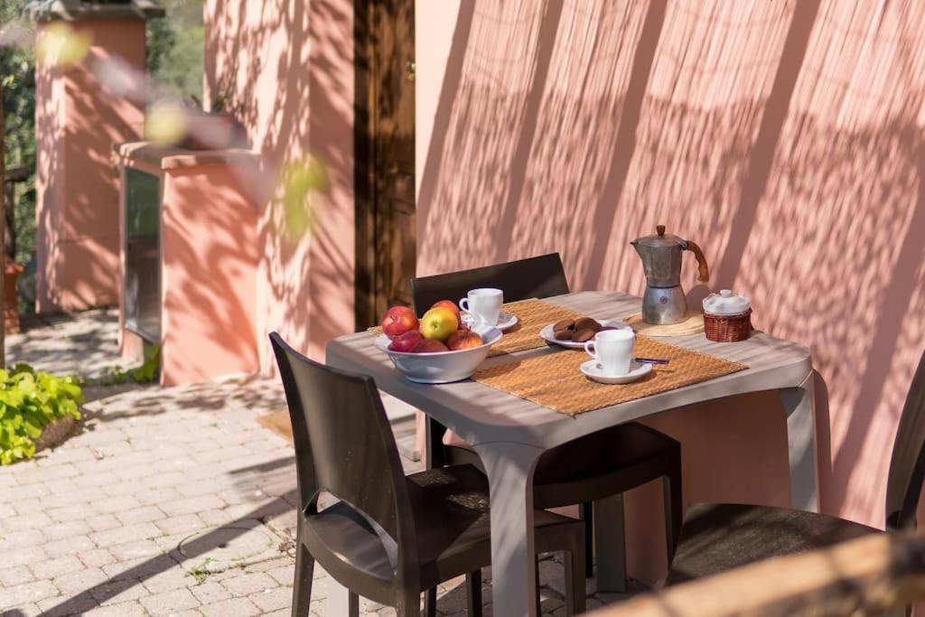 a table with a bowl of fruit on it at Agriturismo De Santis in Castiglioncello