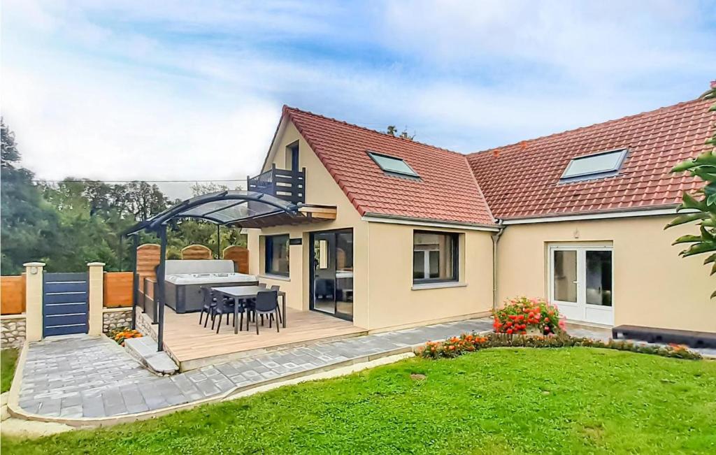 a house with a deck with a table and a grill at Lovely Home In Ledinghem With Kitchen in Seninghem