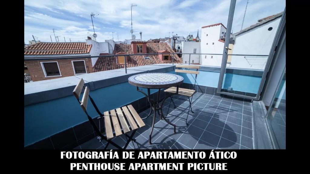 a balcony with a table and chairs on a roof at Apartments Madrid Plaza Mayor-Tintoreros in Madrid