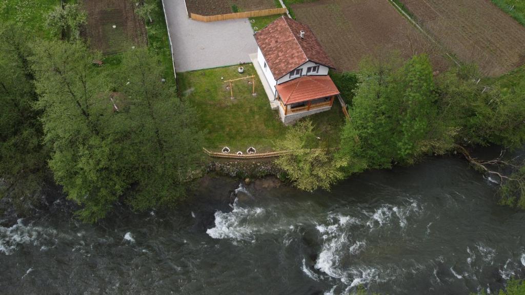 an aerial view of a house next to a river at Apartman Amina Vinac-Jajce in Jajce