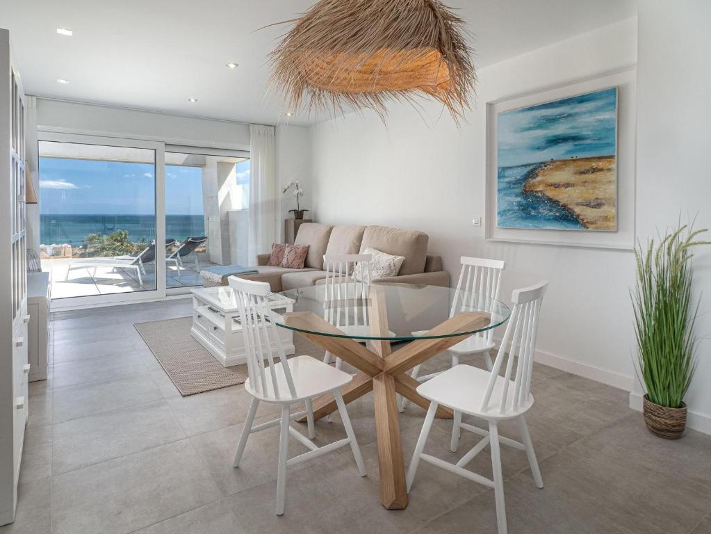a living room with a table and chairs and a couch at Via Celere 2376 Beach & Golf in San Luis de Sabinillas