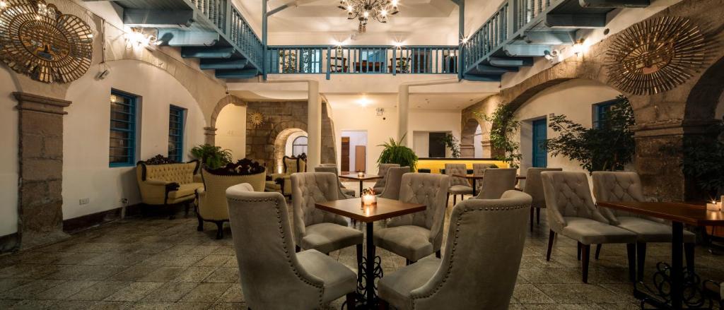 a restaurant with chairs and tables in a room at Hotel Rojas Inn in Cusco