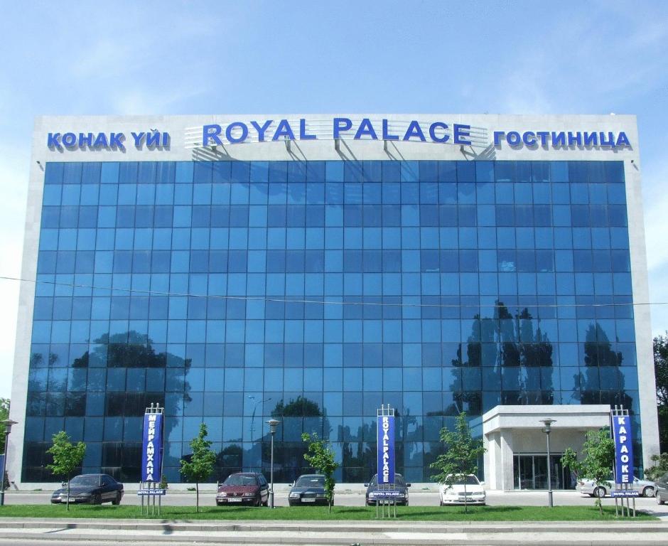 un edificio de cristal con un cartel encima en Royal Palace Hotel, en Almaty