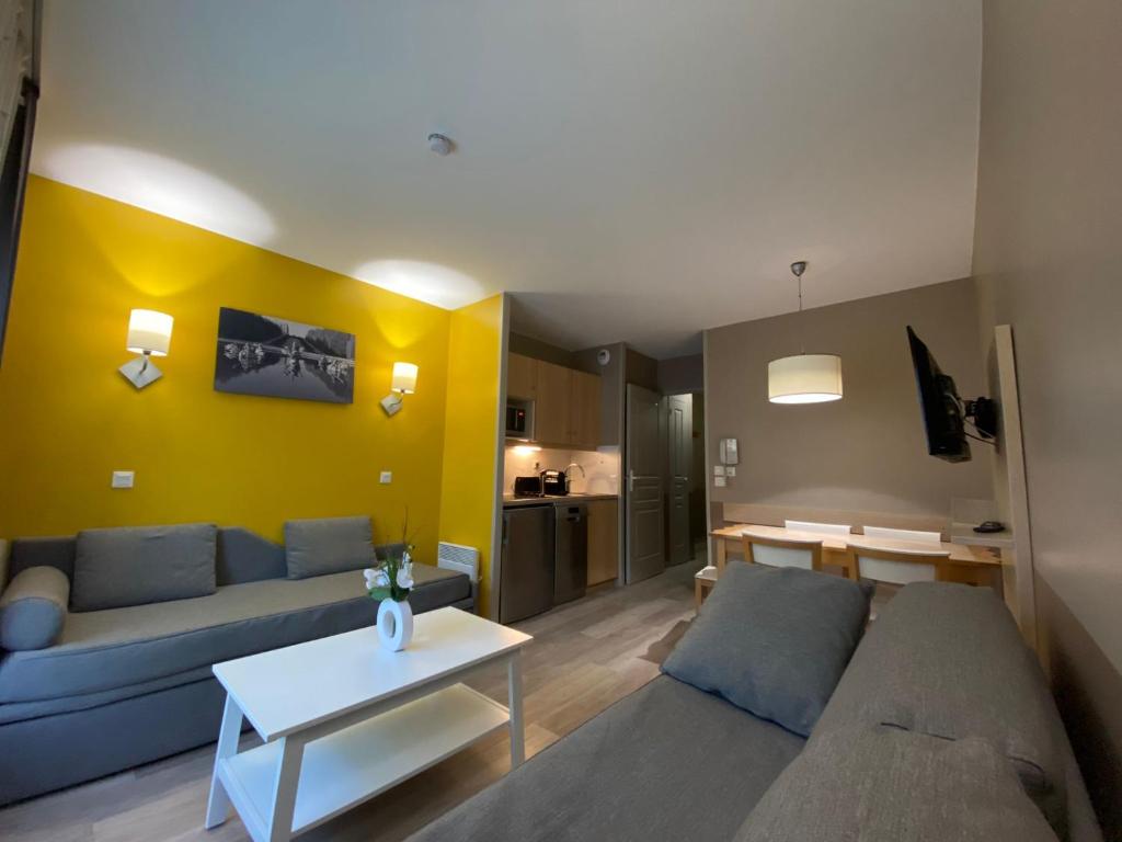 een woonkamer met een bank en een tafel bij Cosy Apartment Disneyland'Val d'Europe'Paris in Serris