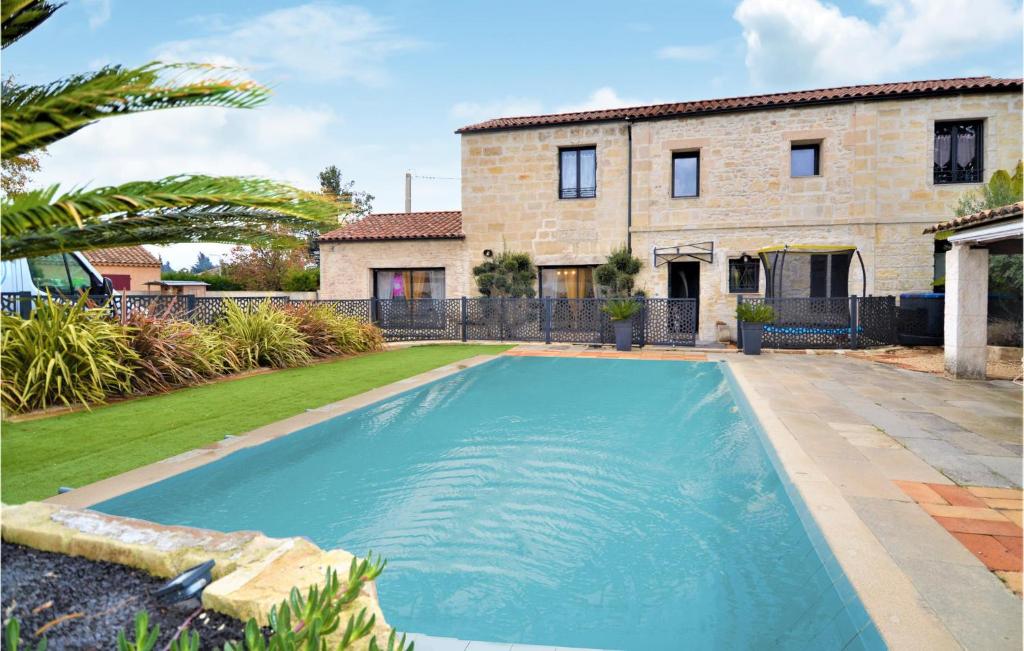 a swimming pool in front of a house at Stunning Home In Beaucaire With Wifi in Beaucaire