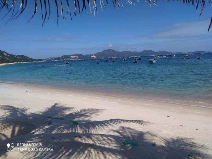 a beach with a bunch of boats in the water at The Sunrise Anh Tu in Cam Ranh