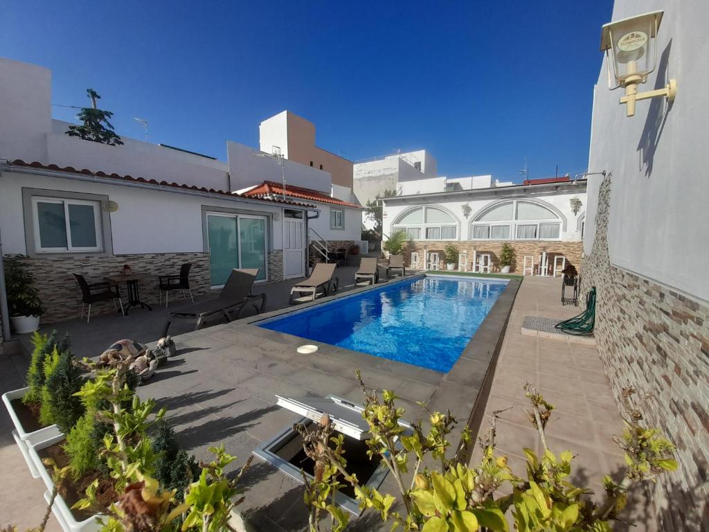 a swimming pool in the backyard of a house at TENERIFE LITTLE VILLAGE S in San Isidro