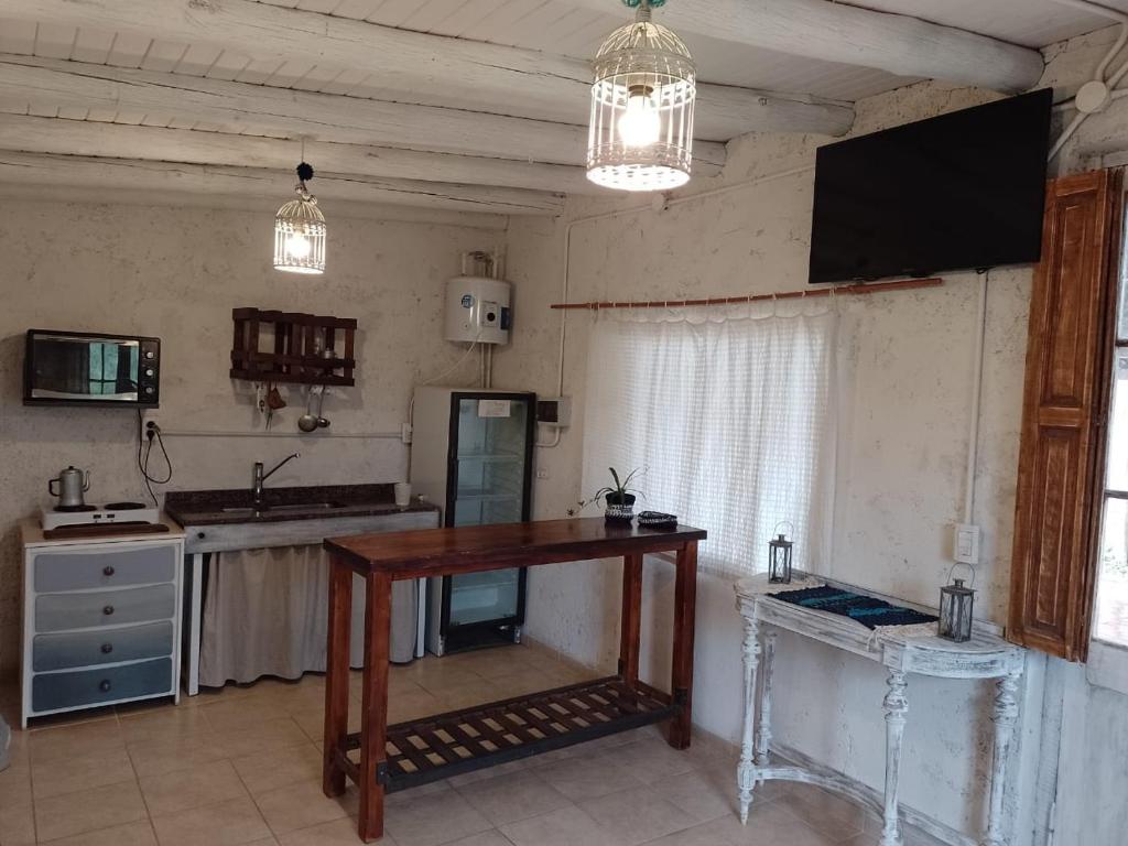 a kitchen with a wooden table in a room at Rincon La Magda in Ciudad Lujan de Cuyo