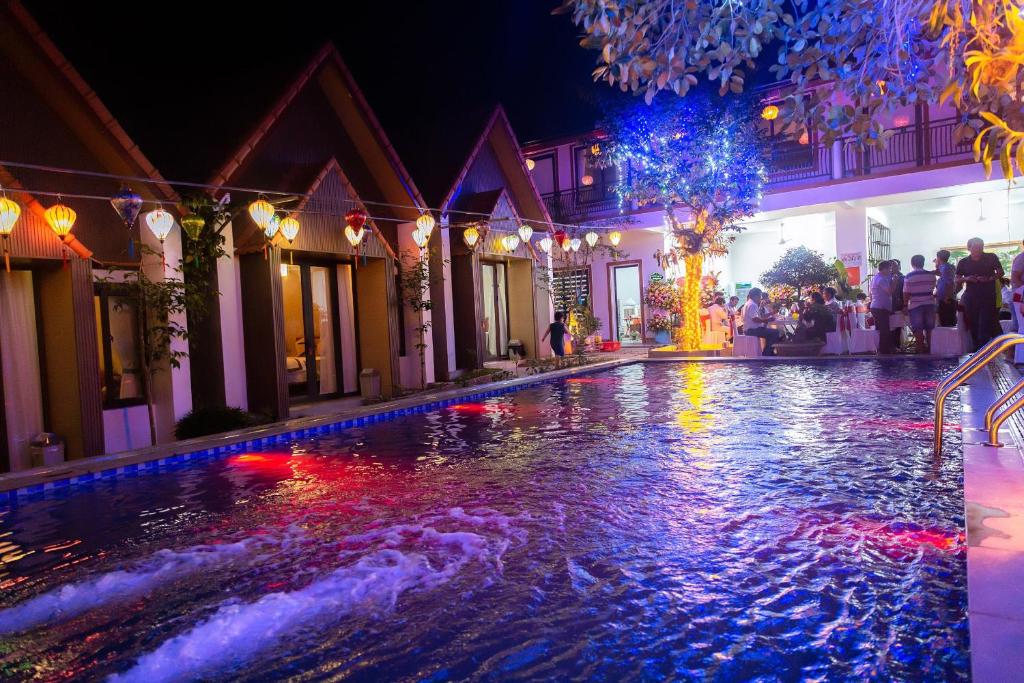 a swimming pool at night with lights in a building at Tam Coc Hao Hao Homestay in Vũ Lâm