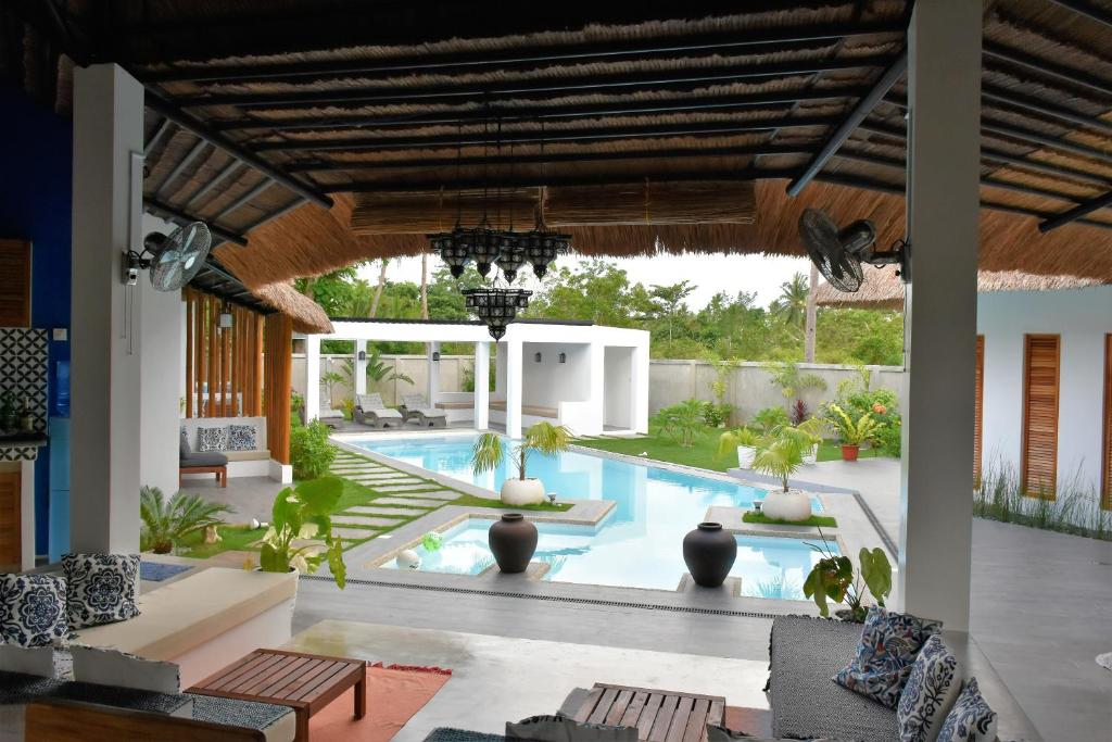 a living room with a pool and a house at Balai Cinta in Panglao