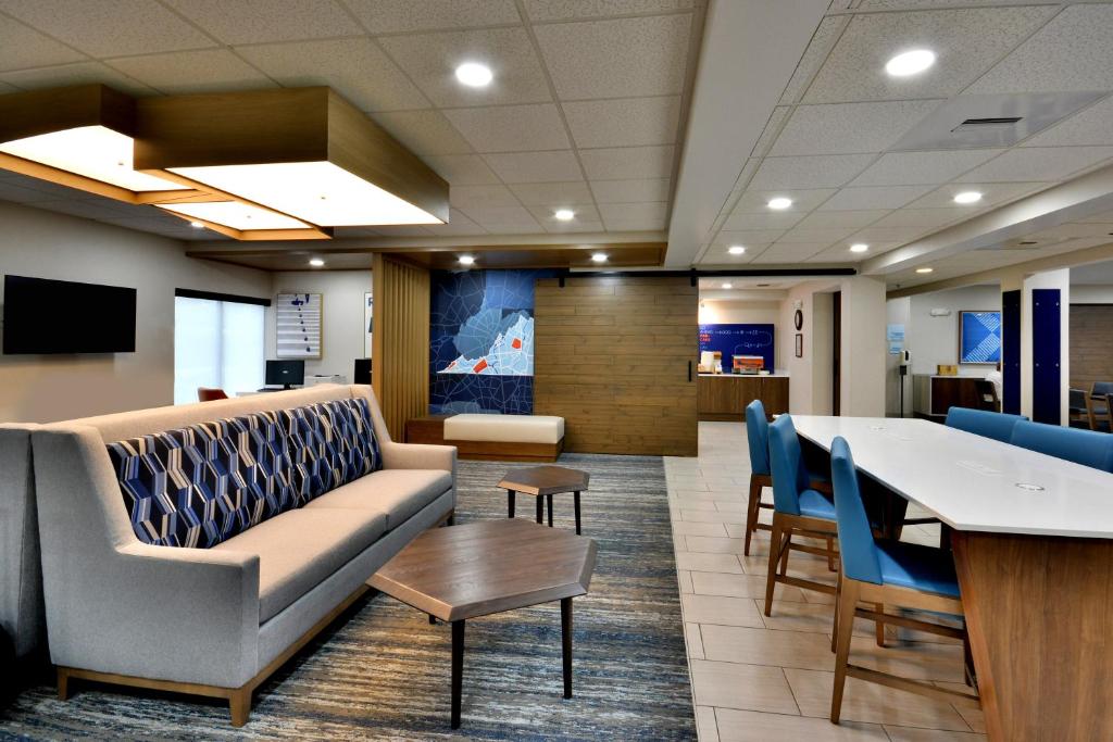 a waiting room with a couch and chairs and a table at Holiday Inn Express Richmond I-64 Short Pump Area, an IHG Hotel in Richmond