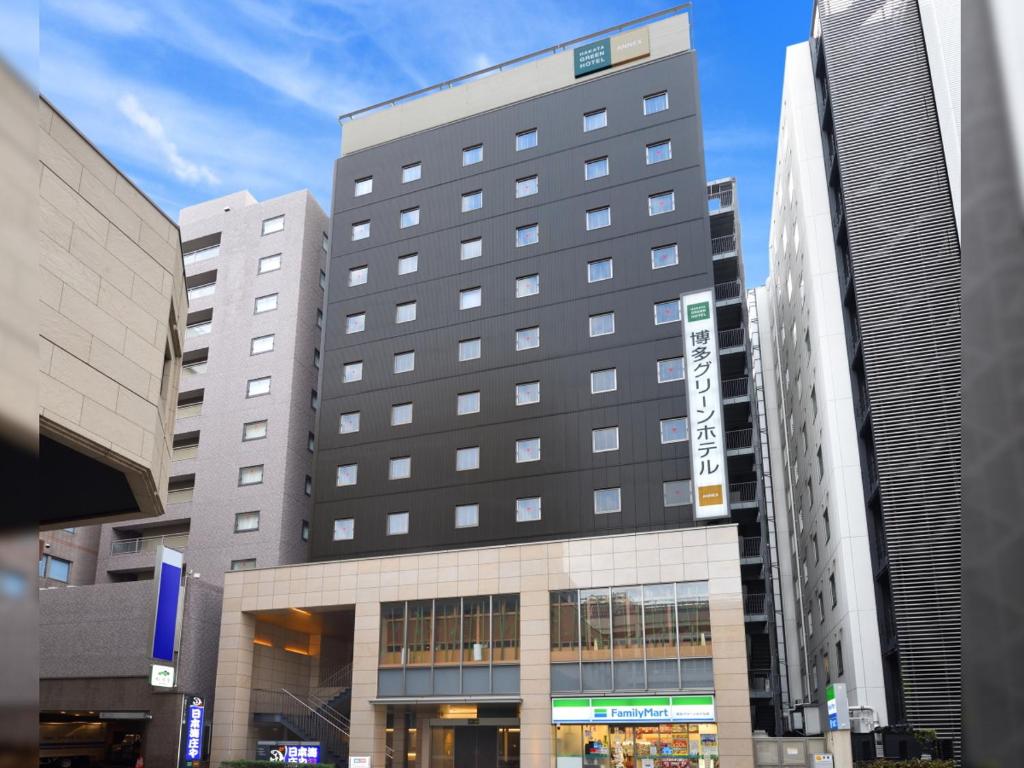 
a large building with a large building behind it at Hakata Green Hotel Annex in Fukuoka
