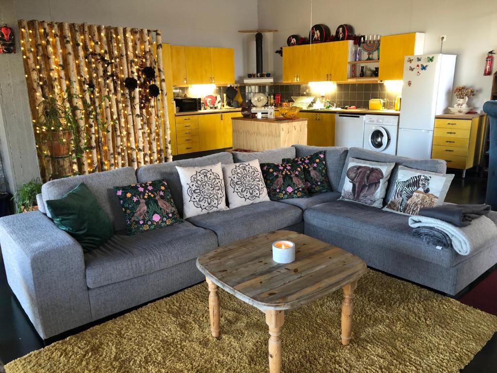 a living room with a couch and a coffee table at Liljekonvalj Cottage overlooking the river sauna in Avesta