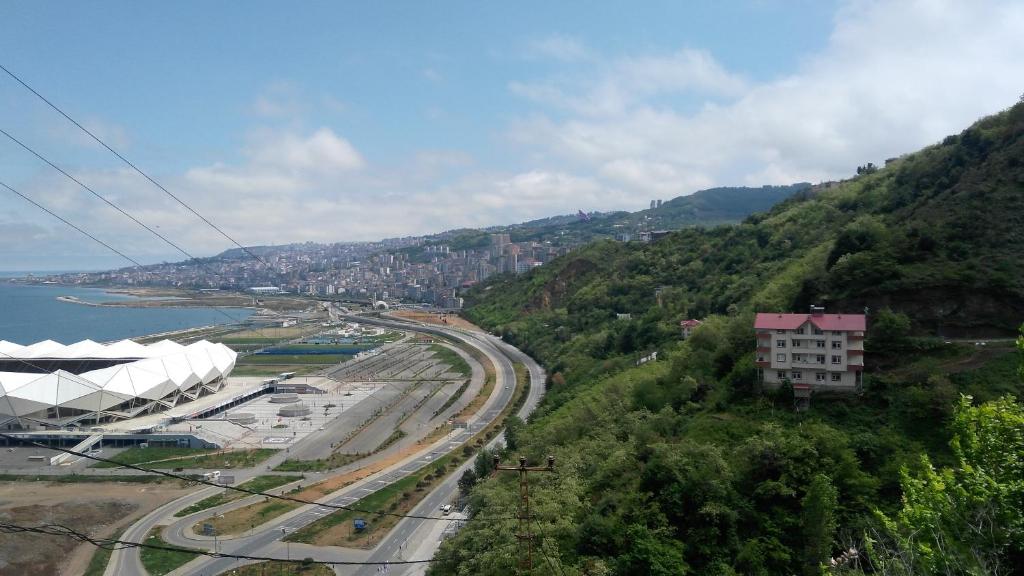 a view of a mountain with a road and a building at Guesthaus Levent in Trabzon